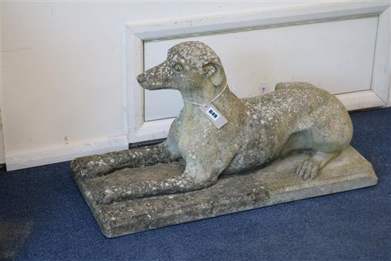 A pair of reconstituted stone recumbent dogs W.73cm